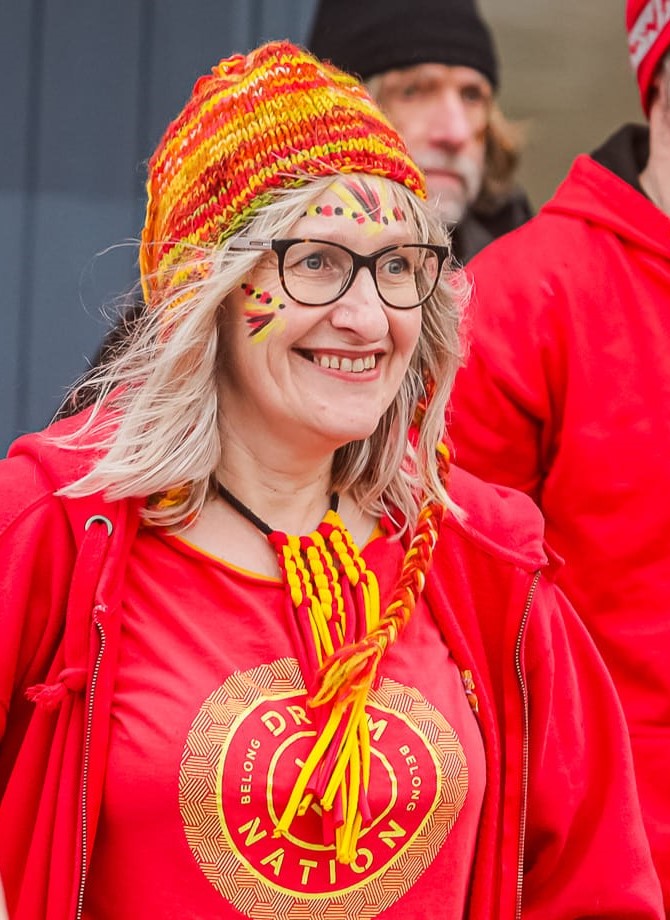 Nicola in a red and yellow Drum Nation uniform